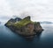 Aerial Drone view of Kalsoy islands on Faroe islands. Aerial panorama of a small white lighthouse located on the edge of