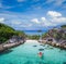 Aerial drone view of in kayak in crystal clear lagoon sea water during summer day near Koh Lipe island in Thailand.