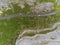 Aerial drone view, landscape in Burren region, county Clare Ireland. Small road between famous rock terrain