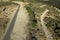 Aerial drone view of landscape sunny day in spring in northern Extremadura, Spain, with road, trees, plants and rocks