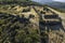 Aerial drone view of landscape sunny day in spring in northern Extremadura, Spain, with road, trees, plants and rocks