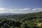 Aerial drone view of landscape sunny day in spring in northern Extremadura, Spain, with road, trees, plants and rocks