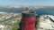 Aerial drone view of large red and white chimney without smoke at sunny day