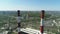 Aerial drone view of large red and white chimney without smoke at sunny day