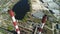 Aerial drone view of large red and white chimney without smoke at sunny day