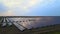 Aerial drone view into large solar panels at a solar farm at summer sunset. Solar cell power plants. footage HDR video