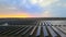 Aerial drone view into large solar panels at a solar farm at summer sunset. Solar cell power plants. footage HDR video