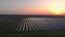 Aerial drone view into large solar panels at a solar farm at summer sunset. Solar cell power plants. footage video 4k.