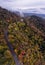 Aerial drone view of a misty foggy mountain road