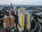 Aerial drone view of modern apartment building in Jakarta central business district with Jakarta cityscape and noise cloud.