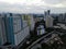 Aerial drone view of modern apartment building in Jakarta central business district with Jakarta cityscape and noise cloud.