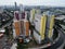 Aerial drone view of modern apartment building in Jakarta central business district with Jakarta cityscape and noise cloud.