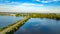 Aerial drone view of motorway road and cycling path on polder dam, cars traffic, North Holland, Netherlands