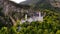 Aerial drone view Neuschwanstein castle on Alps background in vicinity of Munich, Bavaria, Germany, Europe. Autumn