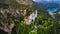 Aerial drone view Neuschwanstein castle on Alps background in vicinity of Munich, Bavaria, Germany, Europe. Autumn