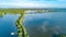 Aerial drone view of path on dam in polder water from above, landscape and nature of North Holland, Netherlands