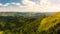 Aerial drone view of picturesque nature with green coniferous forests on the slopes of the mountains in beautiful sunny day