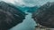 Aerial drone view Plansee lake among snow-capped mountains in Tyrolean Alps, Austria late autumn in cloudy weather