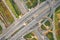 Aerial drone view of road interchange or highway intersection with busy urban traffic in modern city. Traffic jam aerial view