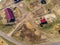 Aerial drone view of rural horse farm or ranch. Village or countryside with horse stables and barns