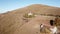 Aerial drone view of the Sanctuary on Linzone mountain, province of Bergamo. Cows are grazing near the church