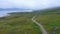 Aerial Drone View of Scotland Highlands Road Trip Driving Holiday in Mountains, with Car on Scottish