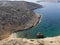 Aerial drone view of Shipwreck Olympia boat in Amorgos island during summer holidays, at the coastal rocky area, people on the