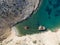 Aerial drone view of Shipwreck Olympia boat in Amorgos island during summer holidays, at the coastal rocky area, people on the