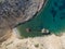 Aerial drone view of Shipwreck Olympia boat in Amorgos island during summer holidays, at the coastal rocky area, people on the
