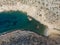 Aerial drone view of Shipwreck Olympia boat in Amorgos island during summer holidays, at the coastal rocky area, people on the