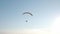 Aerial drone view shot of mechanical hang glider flying in blue sky. V2