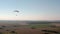 Aerial drone view shot of mechanical hang glider flying in blue sky. V3