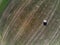 Aerial drone view of a single hay bale on empty agricultural field