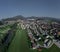 Aerial drone view of skofja loka looking towards west, with lubnik and other hills in the background. Beautiful slovenian city