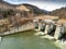 Aerial drone view, small dam over Olt river at springtime