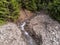 Aerial drone view, small flooded mountain creek  flowing