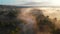 Aerial drone view of sunrise over misty river