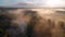 Aerial drone view of sunrise over misty river