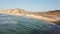 Aerial drone view of surfers beach, calm water and geology and typical vegetation of Angola