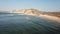 Aerial drone view of surfers beach, calm water and geology and typical vegetation of Angola