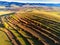 Aerial drone view, terraced agricultural fields near a small village