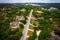 aerial drone view in the Texas Hill Country with large homes along hill tops