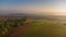 Aerial drone view to long paths between huge fields at sunny morning.