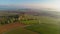 Aerial drone view to long paths between huge fields at sunny morning.