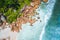 Aerial drone view of tropical paradise like beach with pure crystal clear turquoise water, bizarre granite rocks and