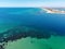 Aerial drone view of a tropical sandy beach dividing an exotic turquoise sea and lake. sand bar in the sea from above, flight over