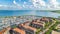 Aerial drone view of typical modern Dutch houses and marina in harbor, architecture of port of Volendam town, Holland, Netherlands