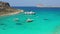 Aerial drone view video of iconic Balos beach and lagoon near Gramvousa island with turquoise clear sea and pure white sand, Crete