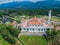 Aerial drone view of a white mosque known as Tun Khalil Mosque with Mount Ledang background at Asahan, Melaka, Malaysia.