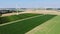 Aerial drone view of wind trubines and green and yellow fields in Normandy, France